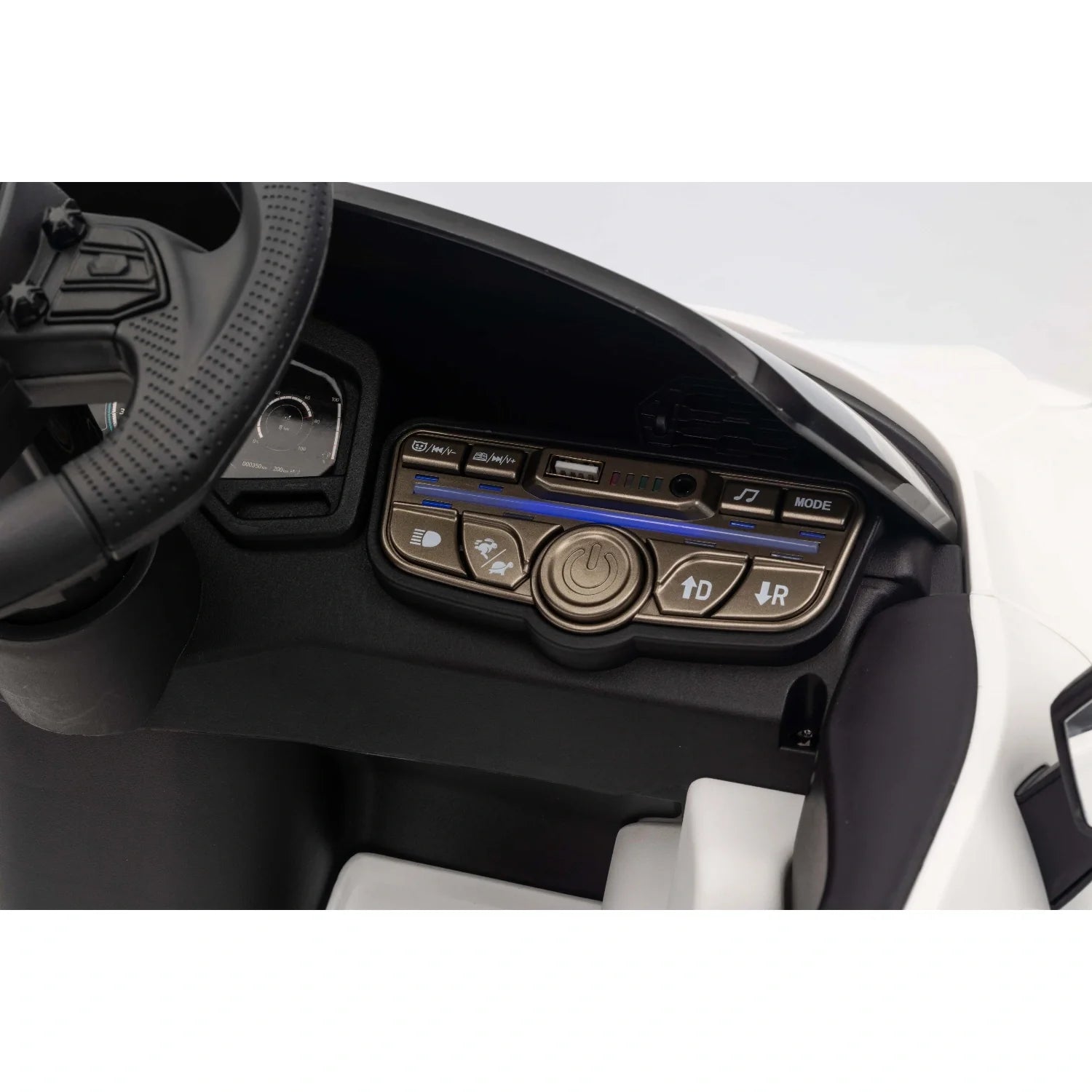 Close-up of white Lamborghini Revuelto kids electric ride-on car dashboard and steering wheel controls.