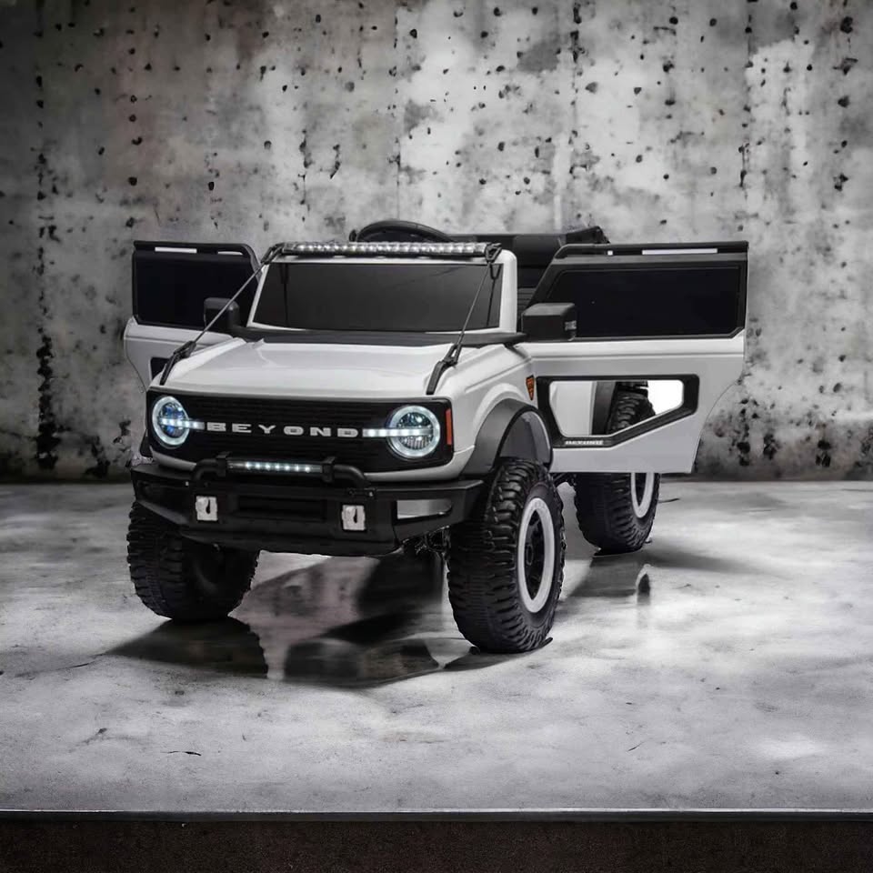 White Ride-On Jeep Beyond 12V 4WD kids UTV with open doors, rugged tyres, headlights, and sleek modern design.