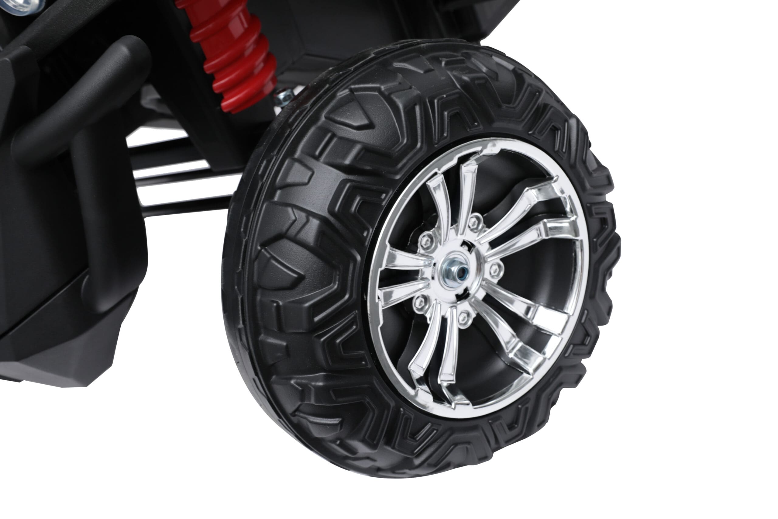 Close-up of a large black EVA off-road tire with chrome alloy rim on a red 24V kids ride-on buggy.