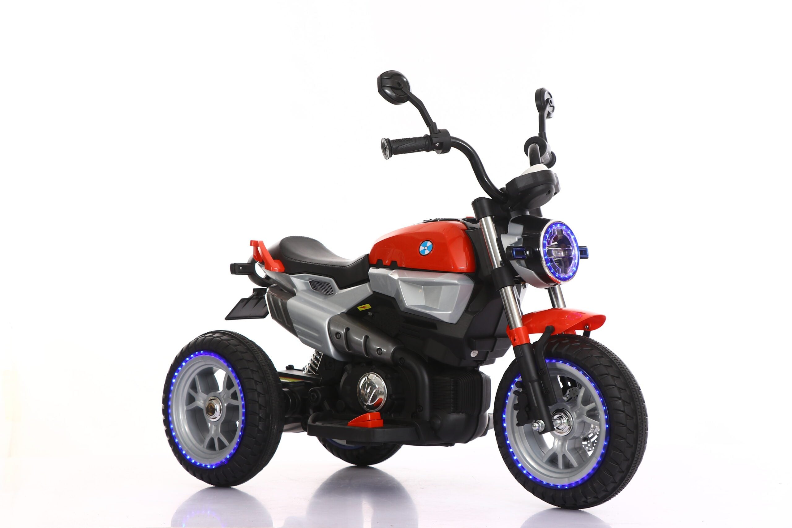 Red 12V electric kids ride-on motorcycle with LED lights and sturdy three-wheel design for ages 3 to 7 years.