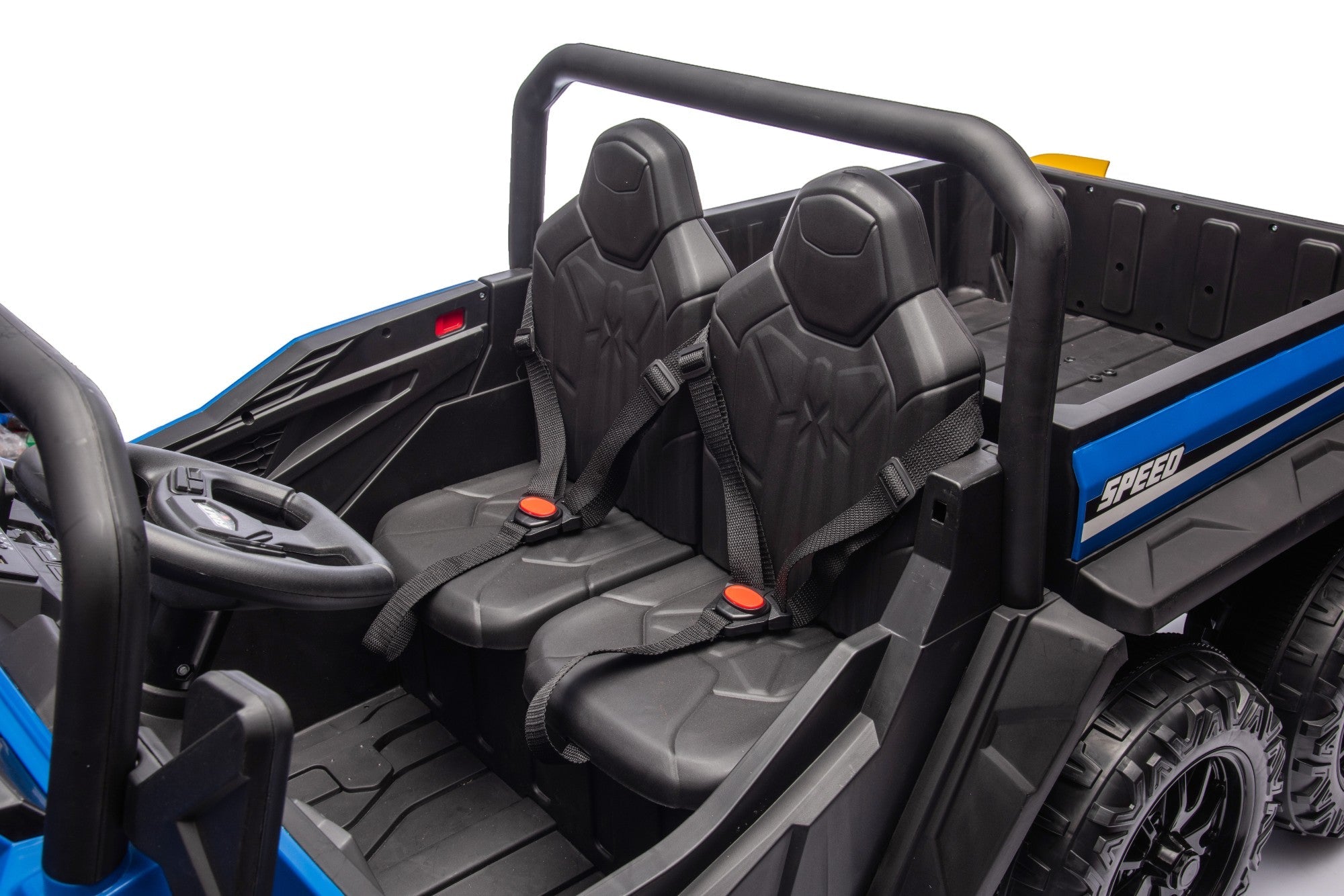 A close-up of the 24V Blue Kids Ride-On Dump Truck by MC Wholesalers shows two black plastic seats with seat belts, a steering wheel, and detailed dashboard controls inside this 6-wheel electric tipper.