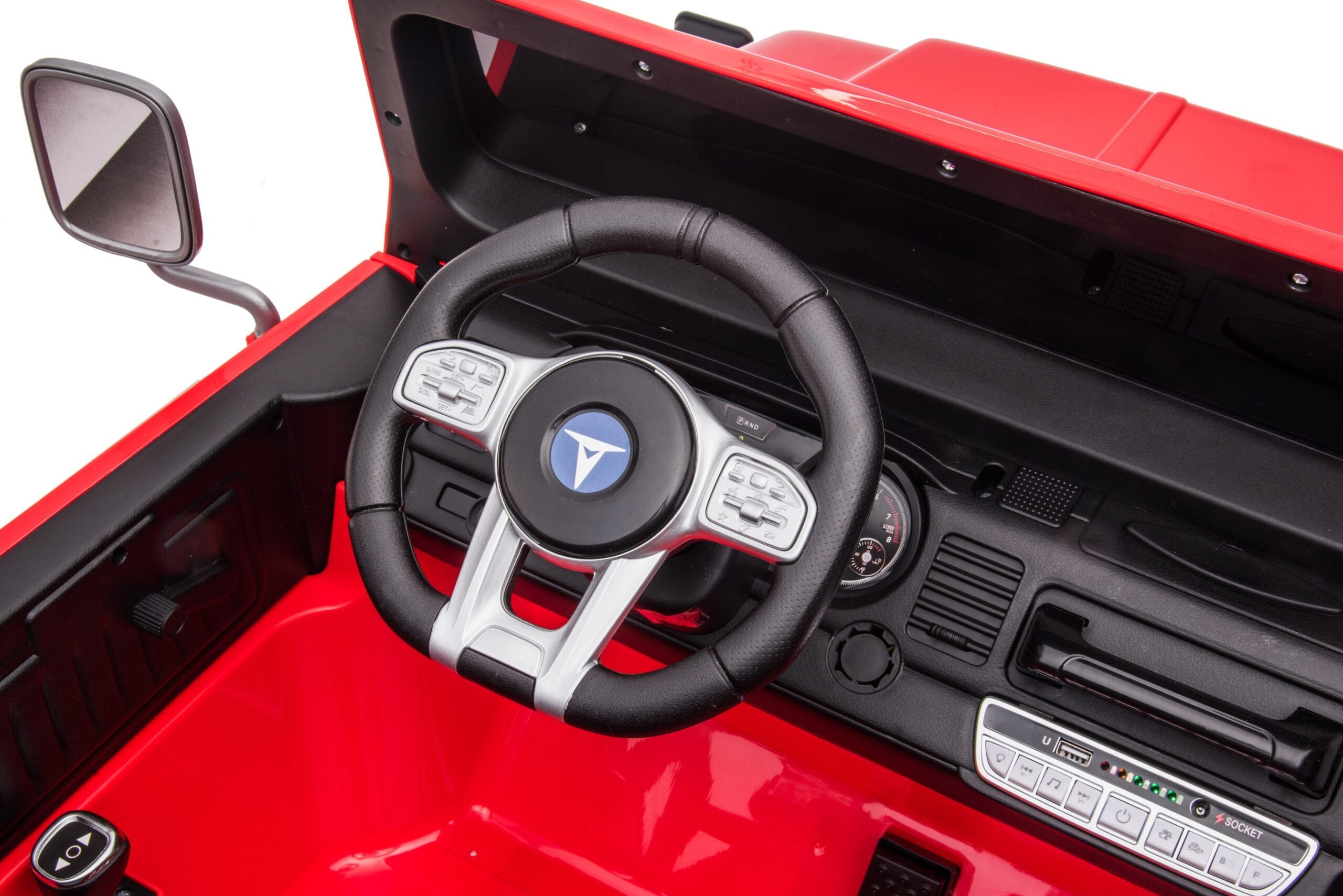 Close-up of the steering wheel and dashboard of a red Toyota FJ40 LandCruiser kids ride-on SUV with detailed controls.