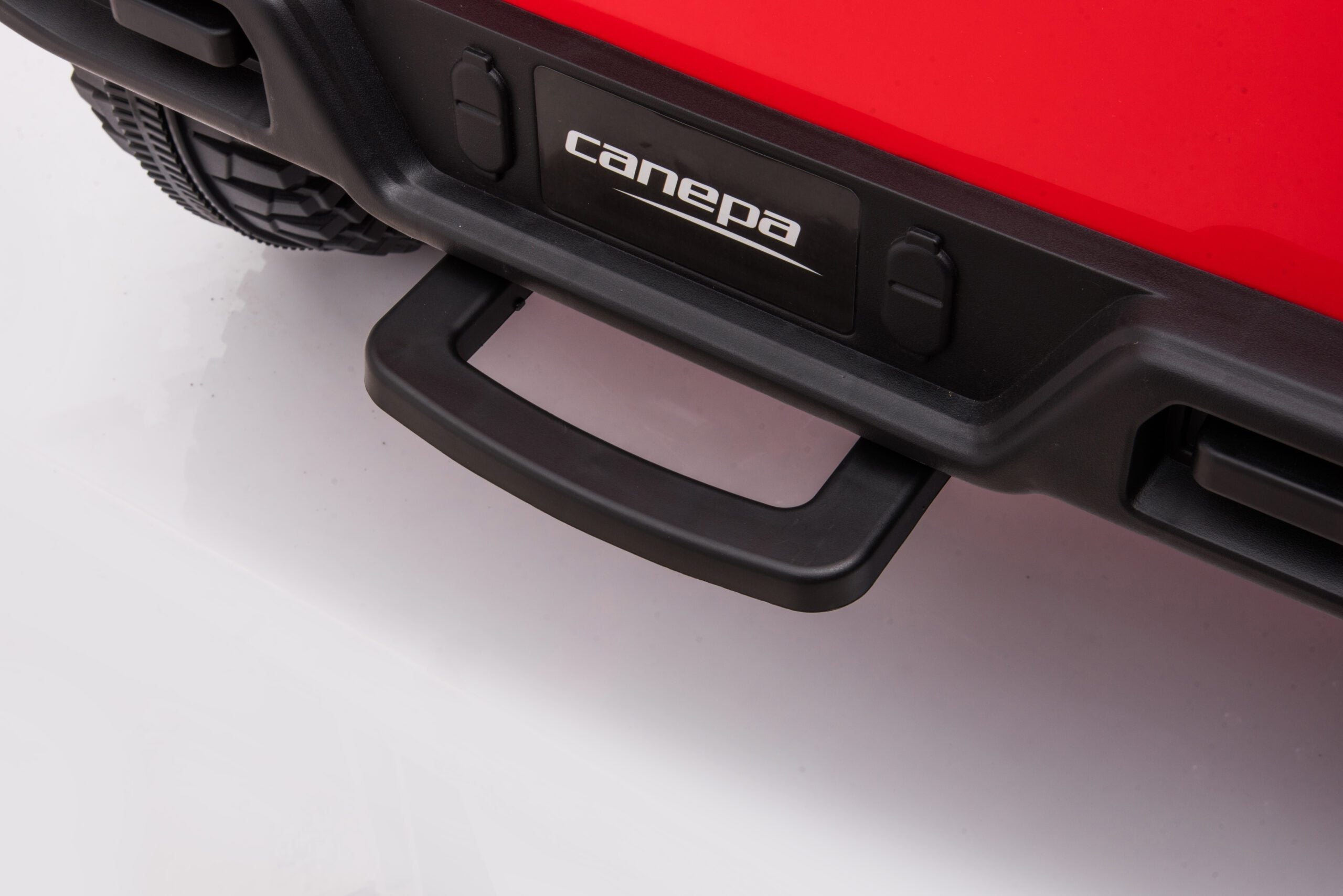 Close-up of the rear black handle and bumper detail on a red Toyota FJ40 LandCruiser kids ride-on SUV.