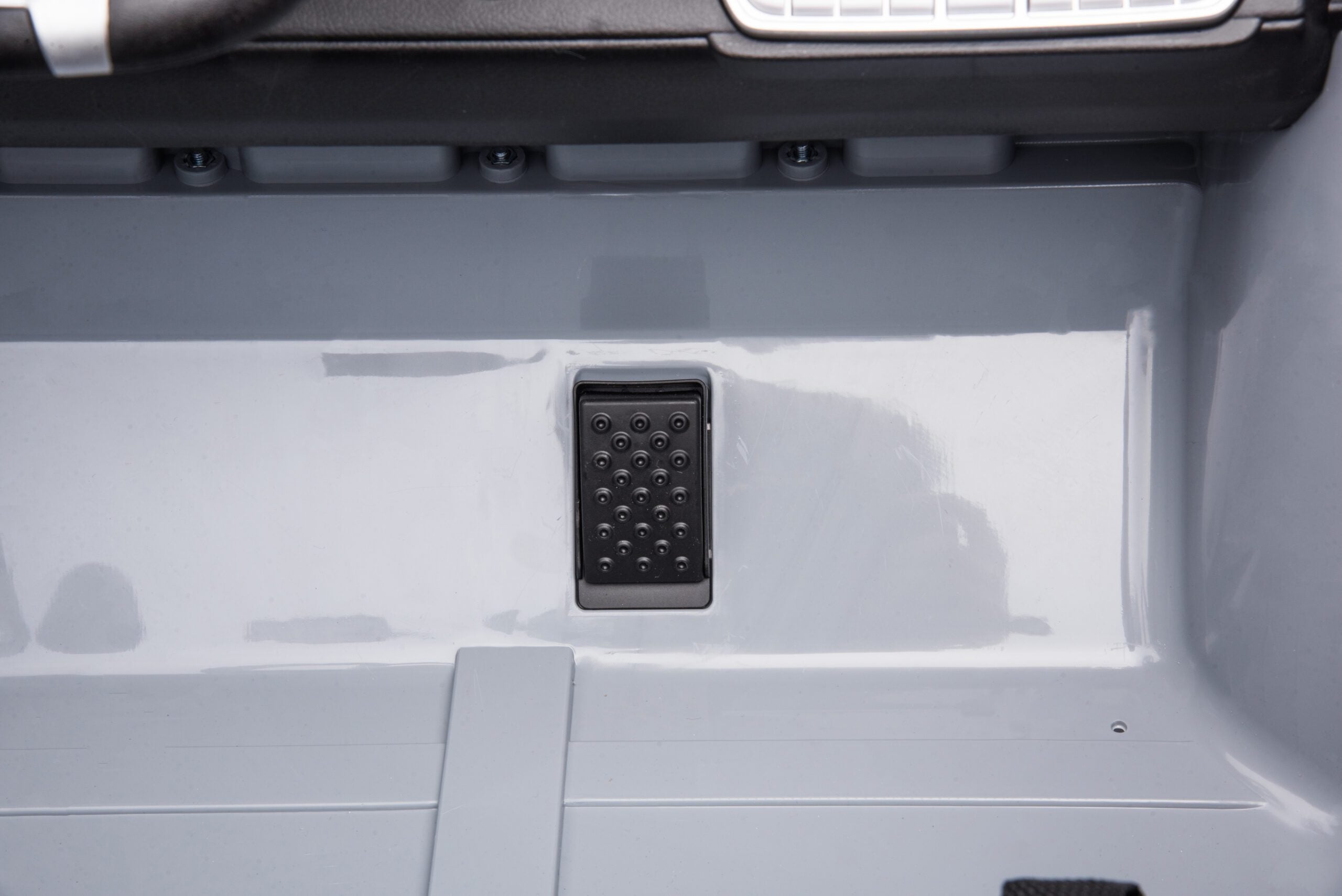 Close-up of the black accelerator pedal inside the red Licensed Toyota FJ-40 24V Kids Ride-On SUV.