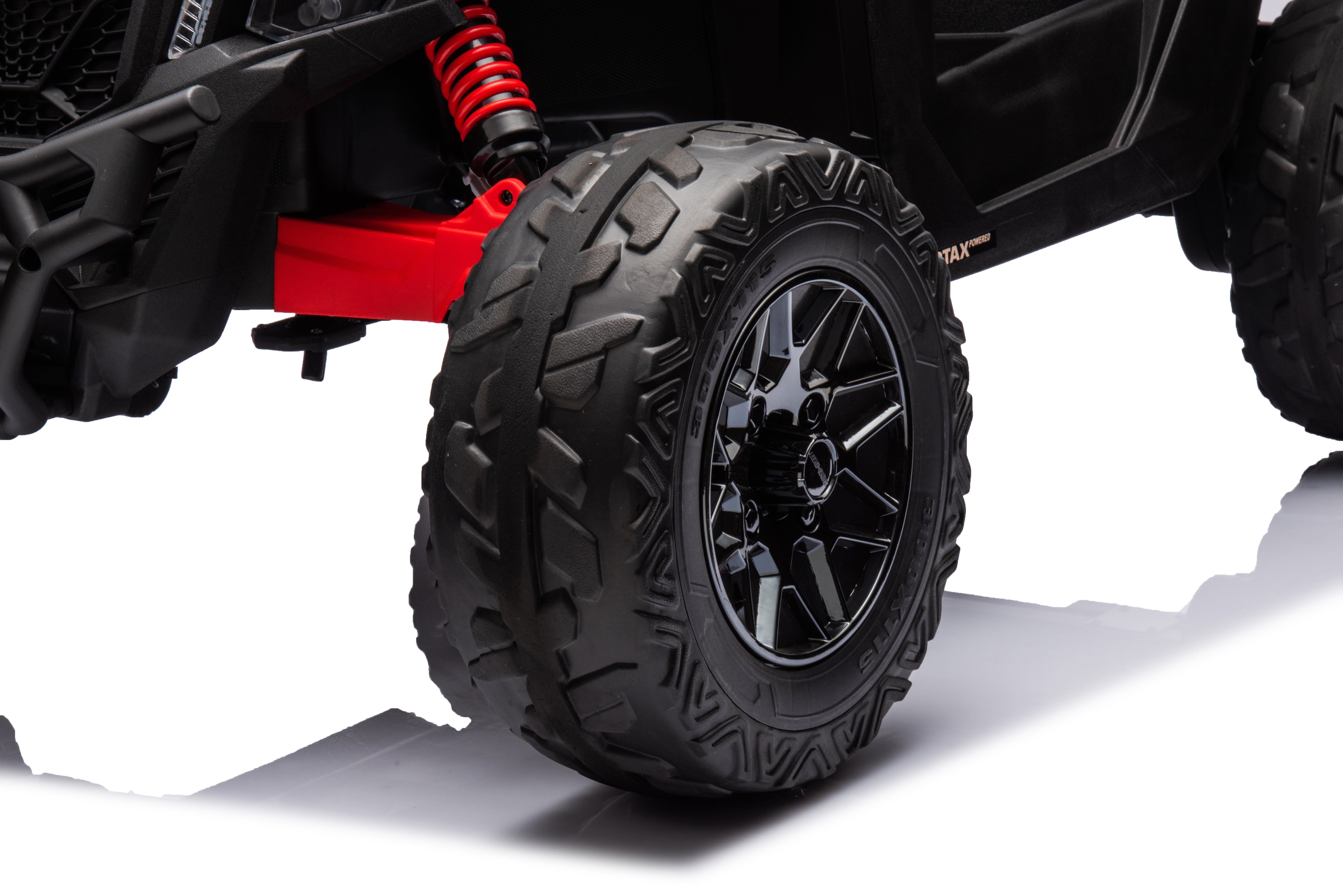 Close-up of the black EVA rubber tire and spring suspension on the Licensed Can-Am Maverick kids ride-on UTV.