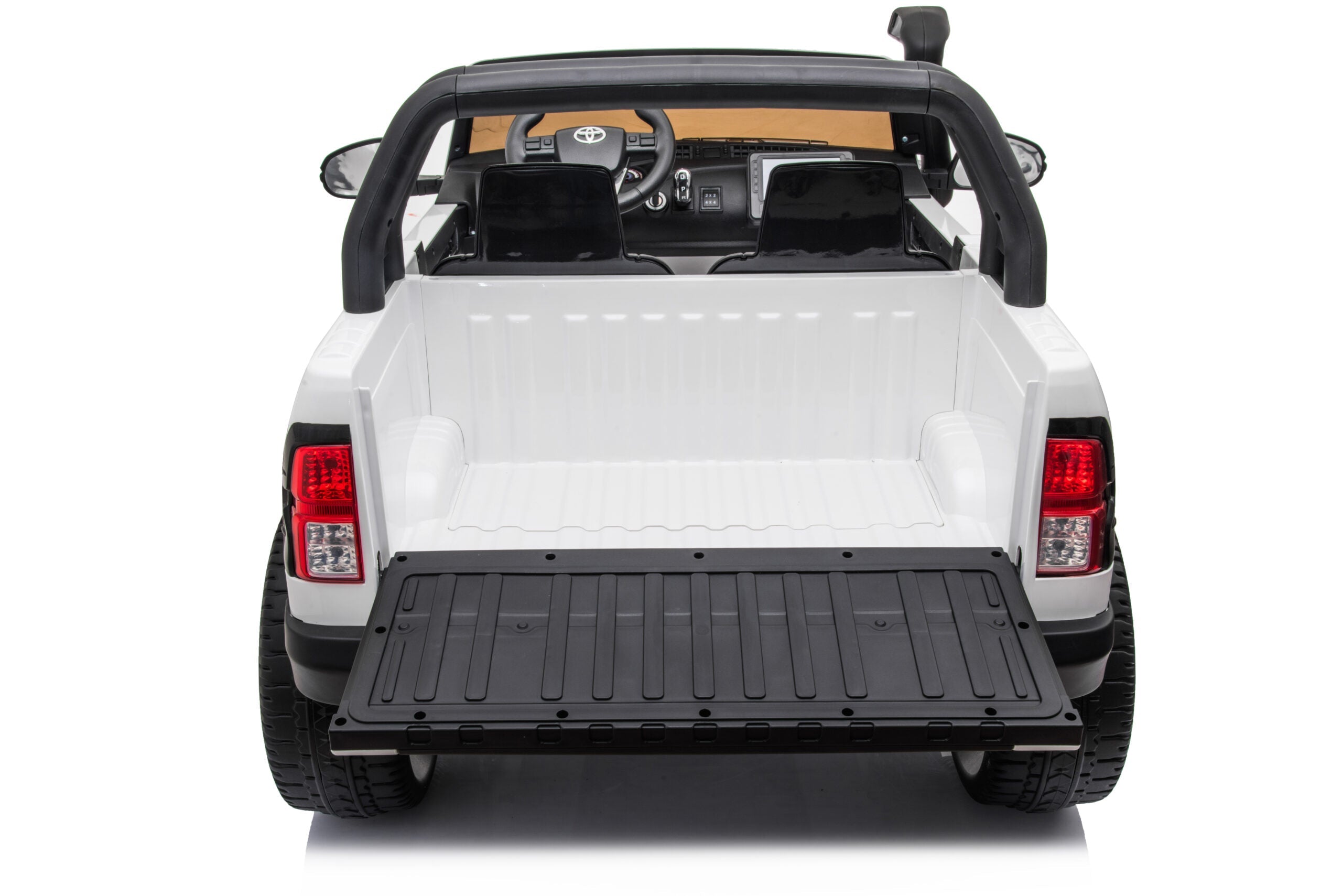 Rear view of white Licensed Toyota Hilux Rugged 24V Kids Ride-On Car with open tailgate and two black seats
