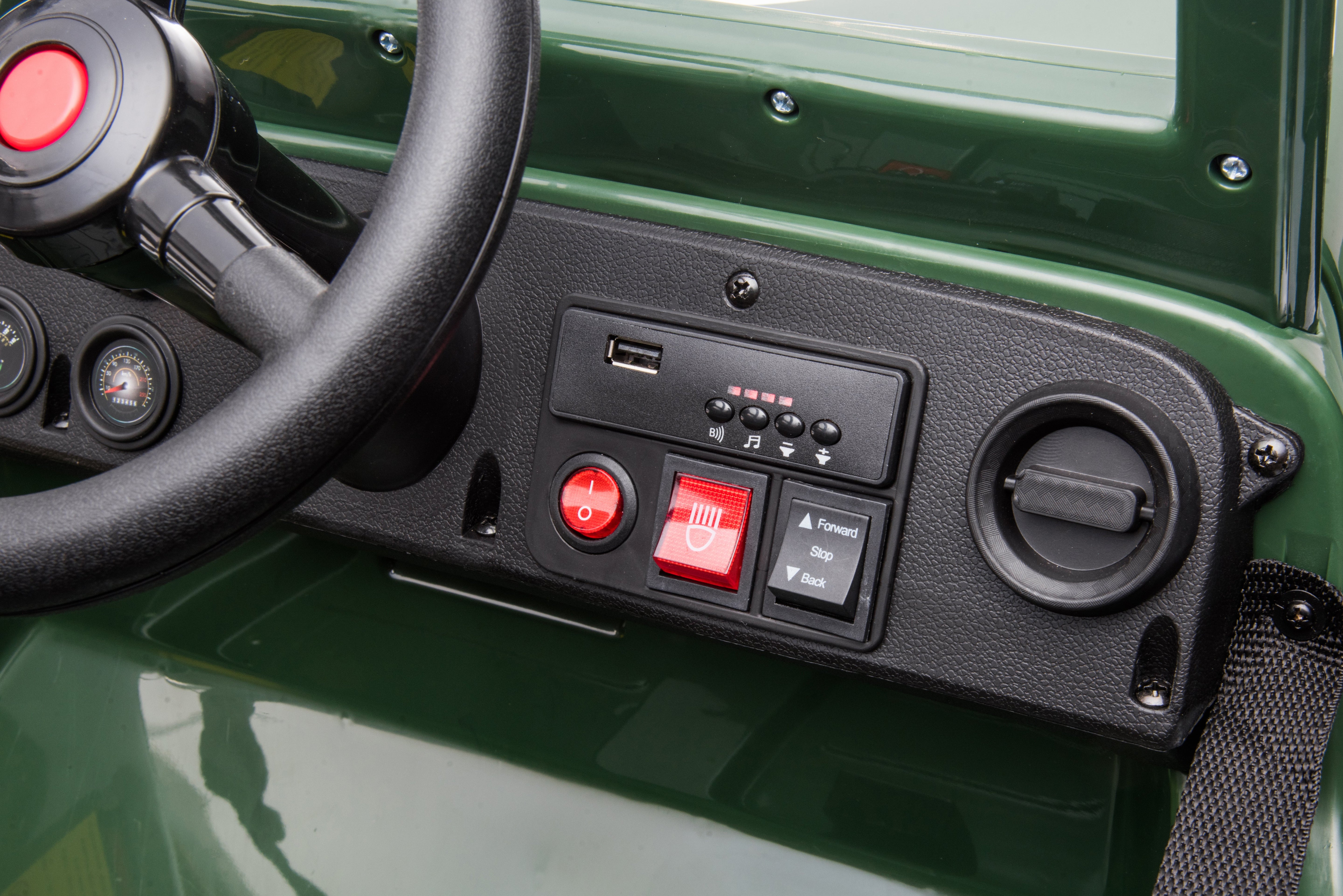 Close-up of dashboard controls on green 12V Kids Army Jeep Willy Ride-On Car with steering wheel and buttons