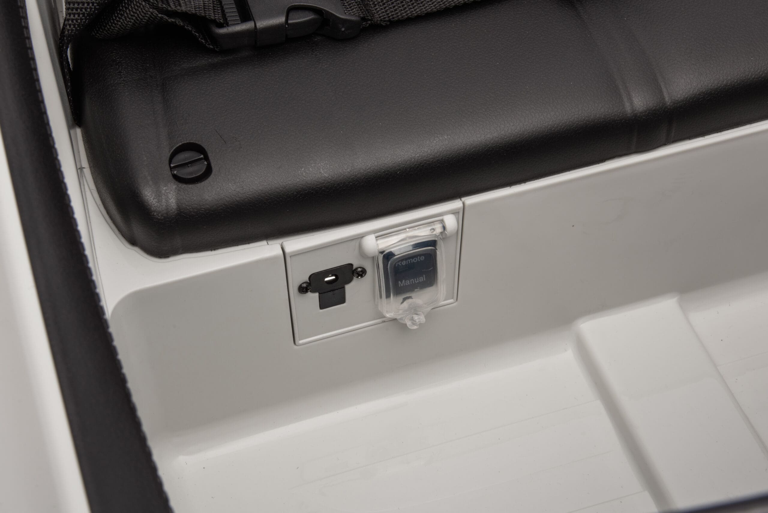 Close-up of USB and charging ports inside the red Mercedes-AMG SL63 kids ride-on car seat area.