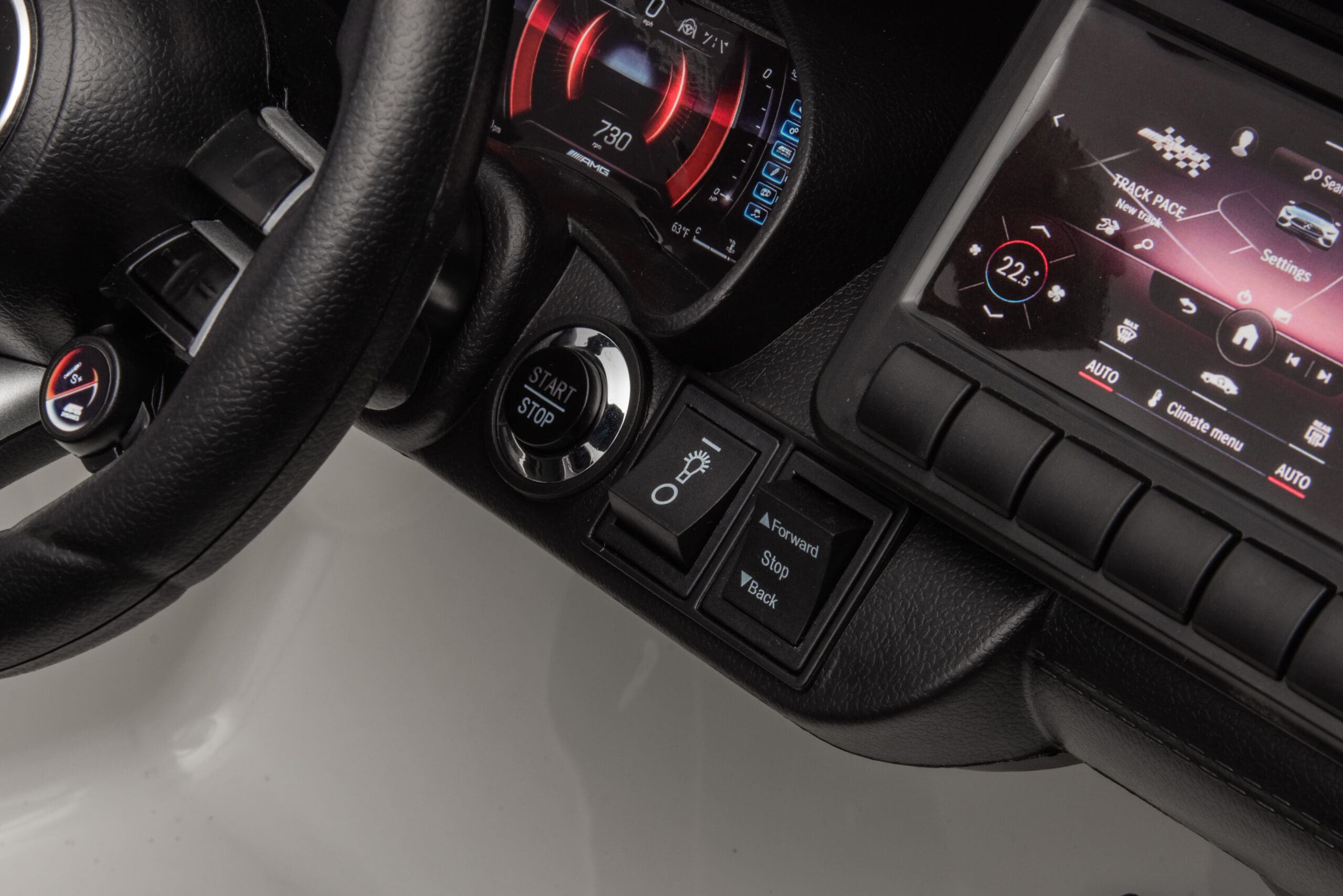 Close-up of the dashboard and steering wheel controls in the red Licensed Mercedes-AMG SL63 12V kids ride-on car.