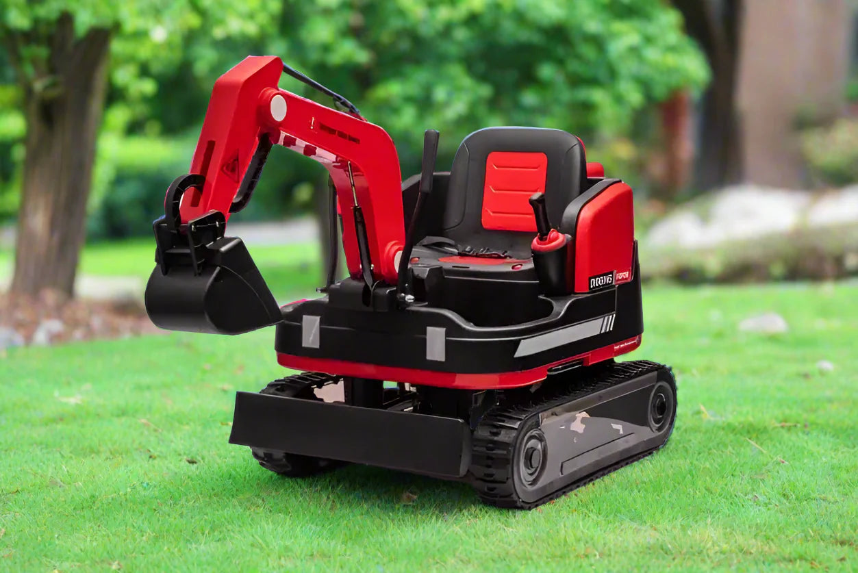 Red 24V kids ride-on excavator with manual digging arm, black seat, and durable tracked wheels on grass outdoors