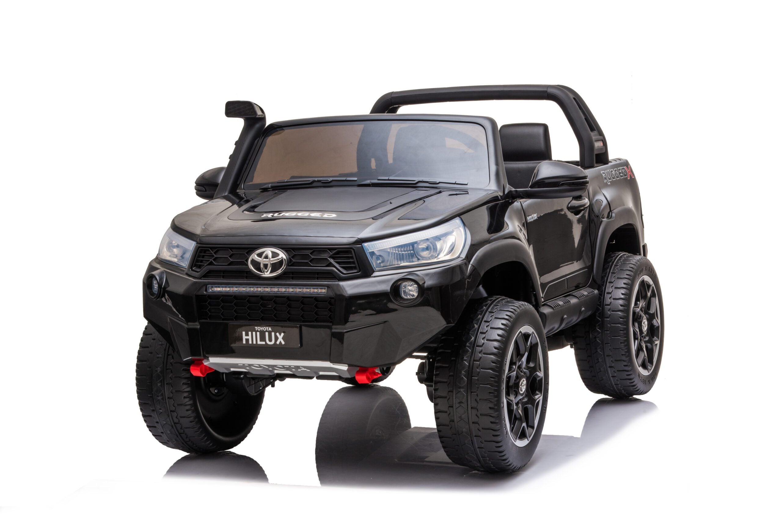Black licensed Toyota Hilux rugged 24V kids electric 2-seater ride-on car with off-road tires and LED lights.