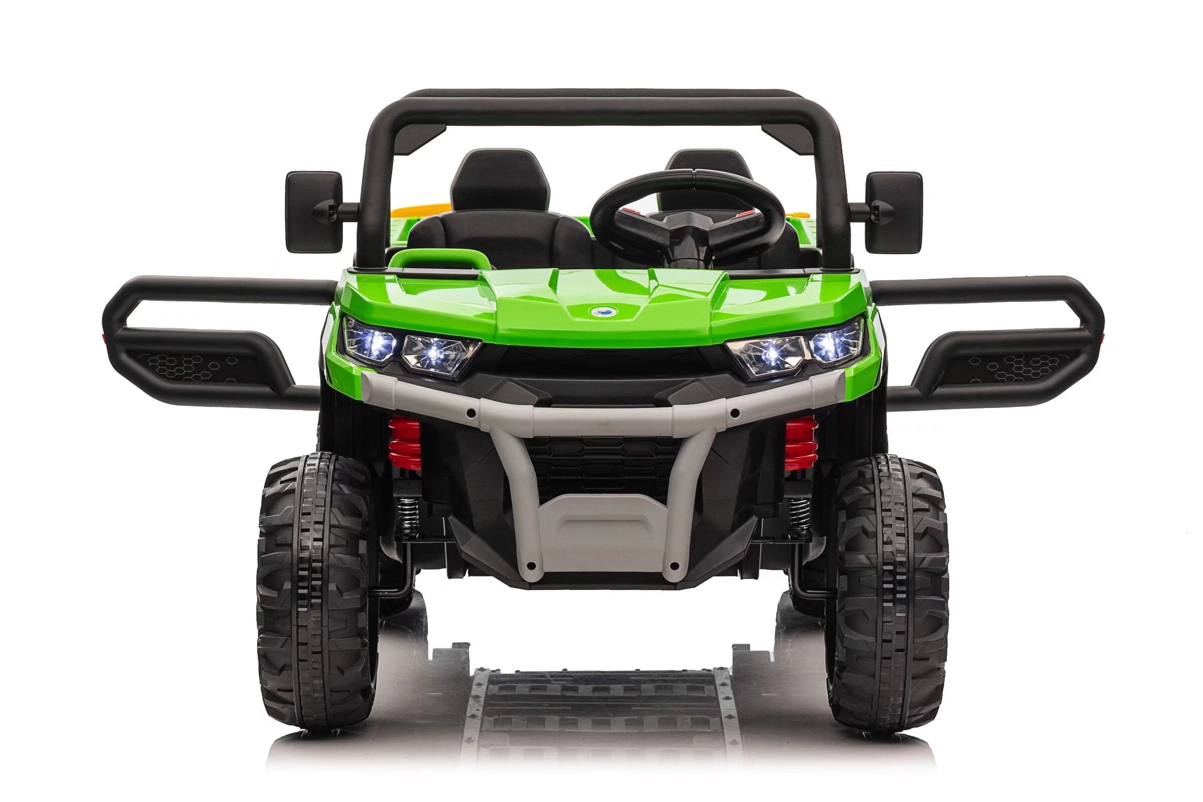 Front view of green 24V kids ride-on dump truck with dual seats, LED headlights, and large EVA rubber tires.