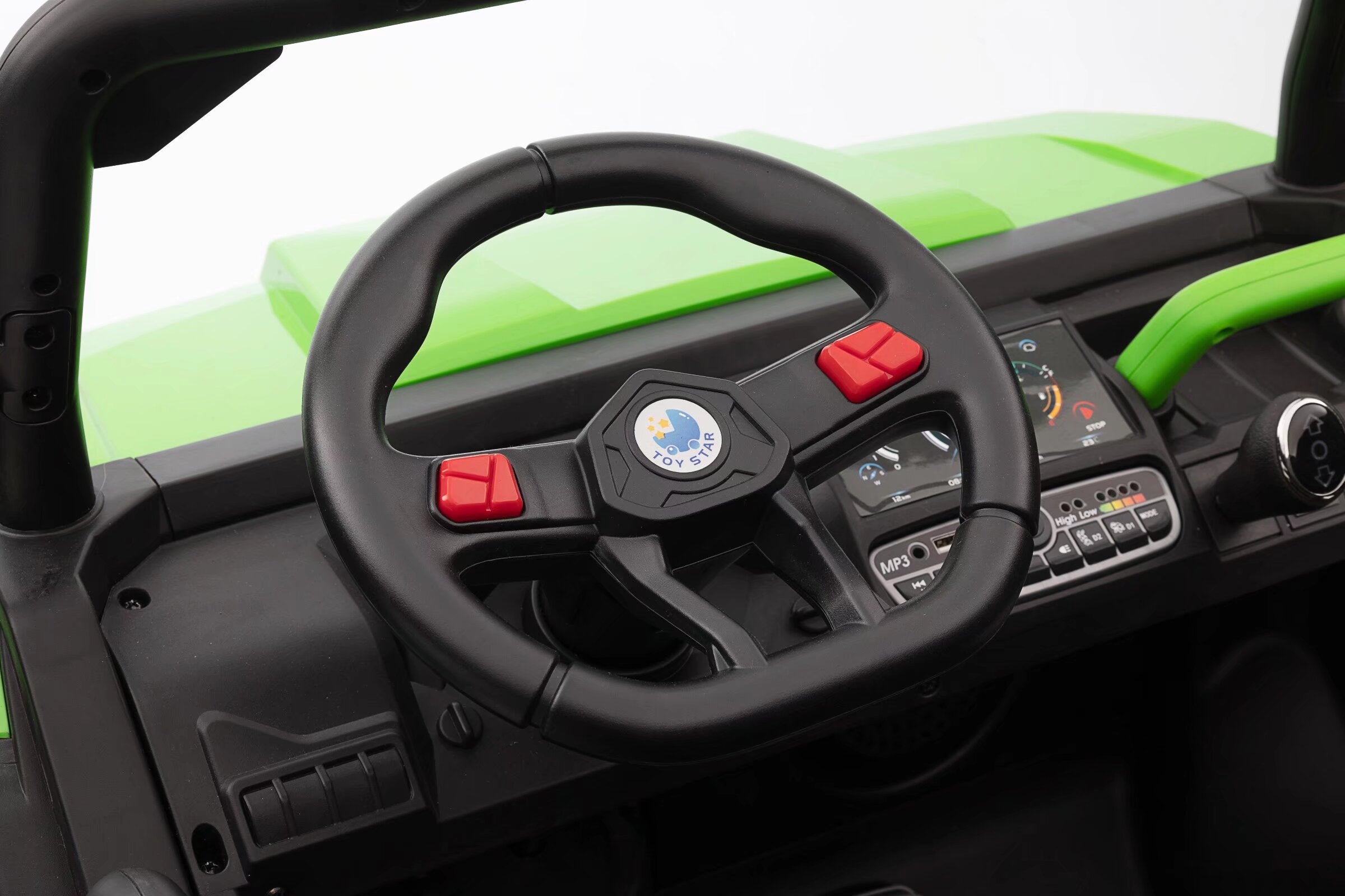 Close-up of the black steering wheel and dashboard controls of a green 24V kids ride-on dump truck.