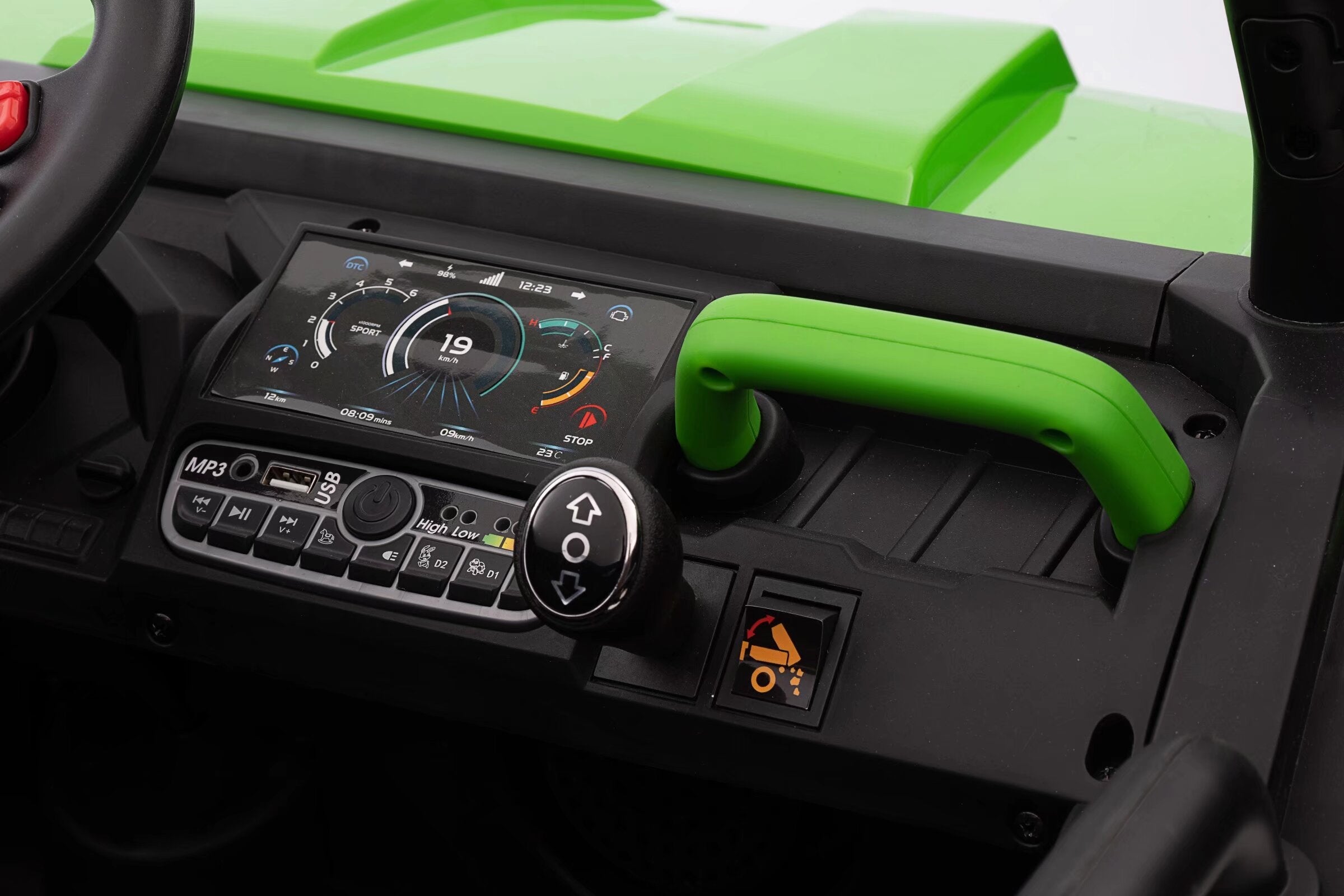 Dashboard and control panel of a green 24V kids ride-on dump truck with display, gear knob, and tipper switch