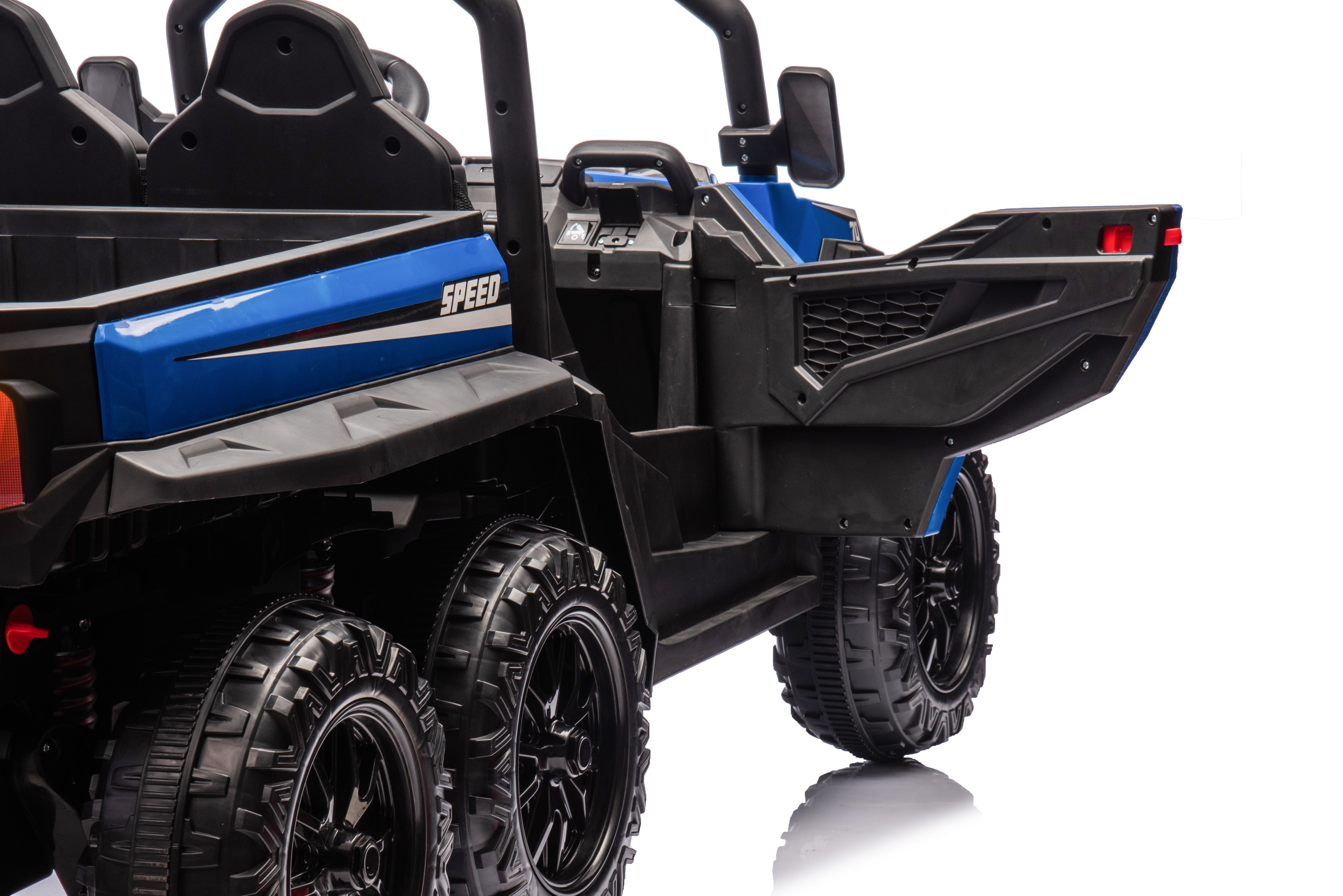 A close-up of the MC Wholesalers 24V Blue Kids Ride-On Dump Truck – 6-Wheel Electric Tipper, featuring six large wheels and an open rear tailgate, photographed on a white background.
