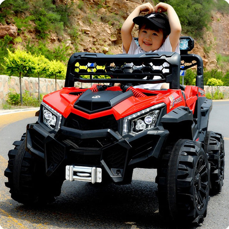 Child enjoying a red 12V kids electric ride-on buggy with rugged wheels on an outdoor road.