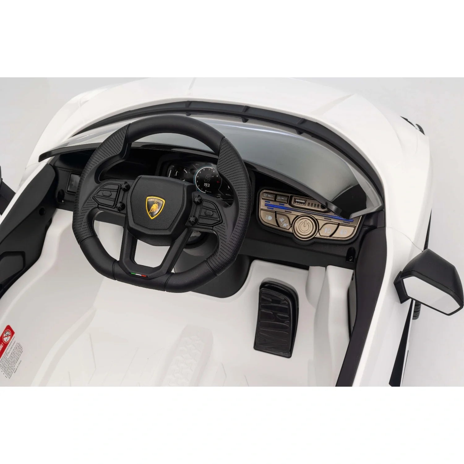 Close-up view of white Lamborghini Revuelto kids electric ride-on car interior with steering wheel and dashboard details
