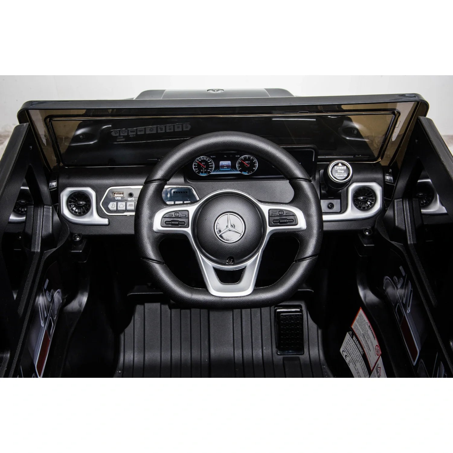 Interior view of a black 12V Mercedes G-Wagon G63 kids electric ride-on car with steering wheel and dashboard details
